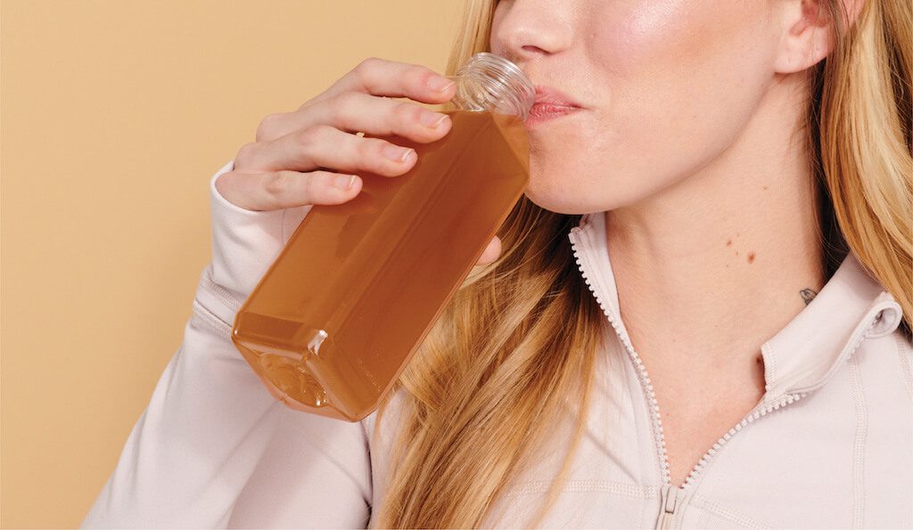 FON_July_Blog_Prebiotics Woman drinking CBD water after doing yoga